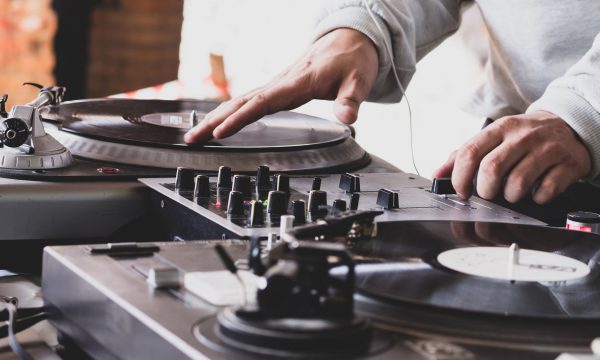 DJ playing music at a hip hop party. analog turntable, Dj uses t DJ playing music at a hip hop party. analog turntable, Dj uses turntable and mixer for scratching.